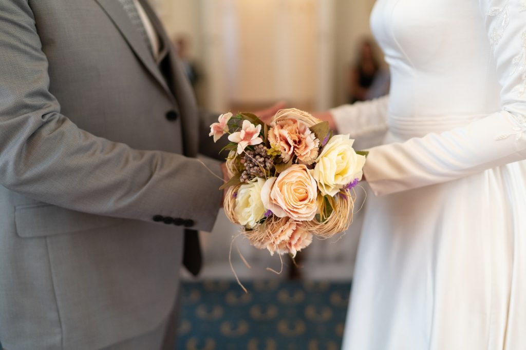 The bride and groom are holding the flowers